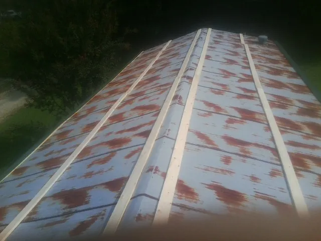 Rusted metal roof panels with new wood purlins before replacement — Storm Damage Roof Repair in Bartonsville by Roofing Brothers