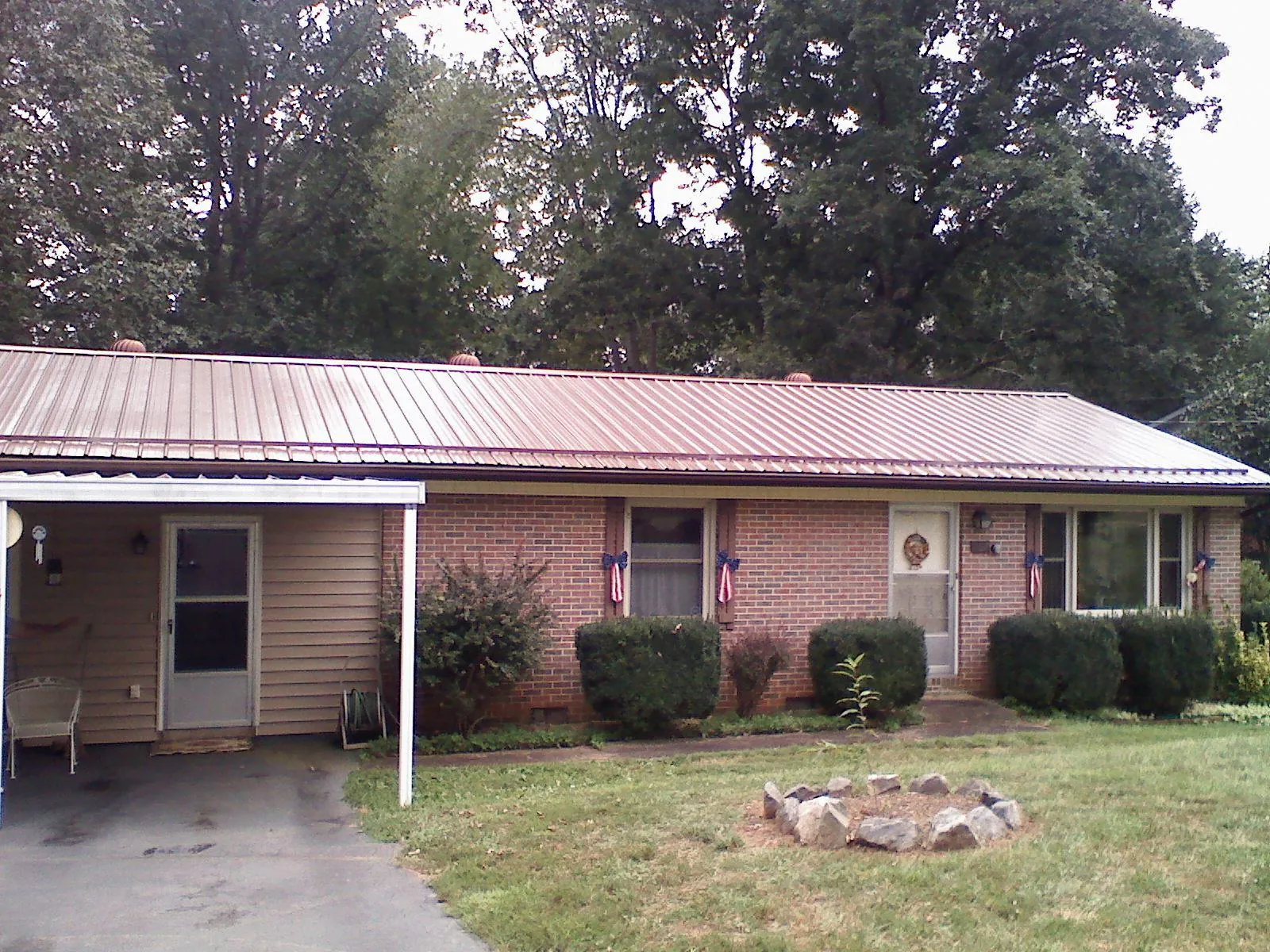 Bronze metal roof and carport on a brick ranch home — Roof Repair work by our crew in Bartonsville